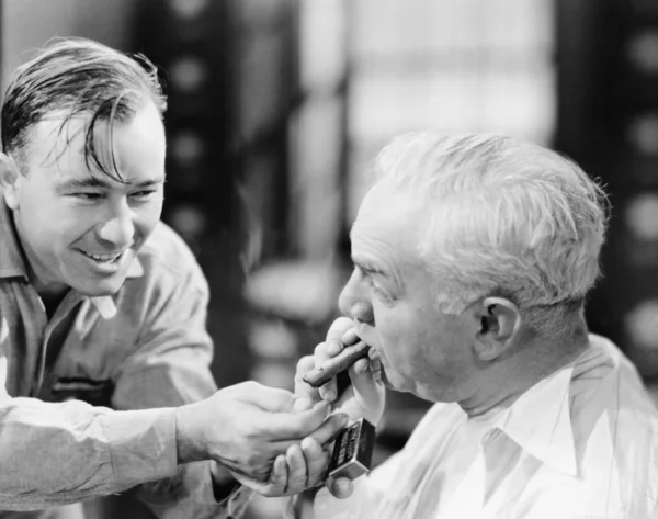 stock image Closeup of man lighting friends cigar