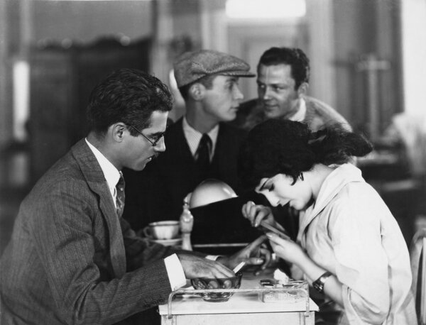 Woman giving man a manicure