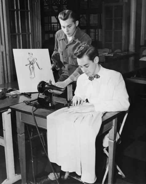 Hombres jóvenes usando máquina de coser — Foto de Stock