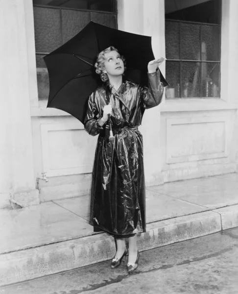 stock image Woman with umbrella testing for rain