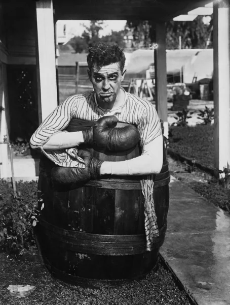 Defeated boxer in barrel outside — Stock Photo, Image