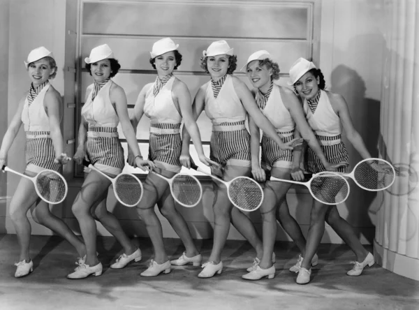 Row of female tennis players in matching outfits Stock Photo