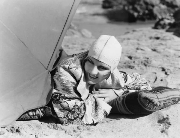 Крупный план женщины лежащей на песке — стоковое фото