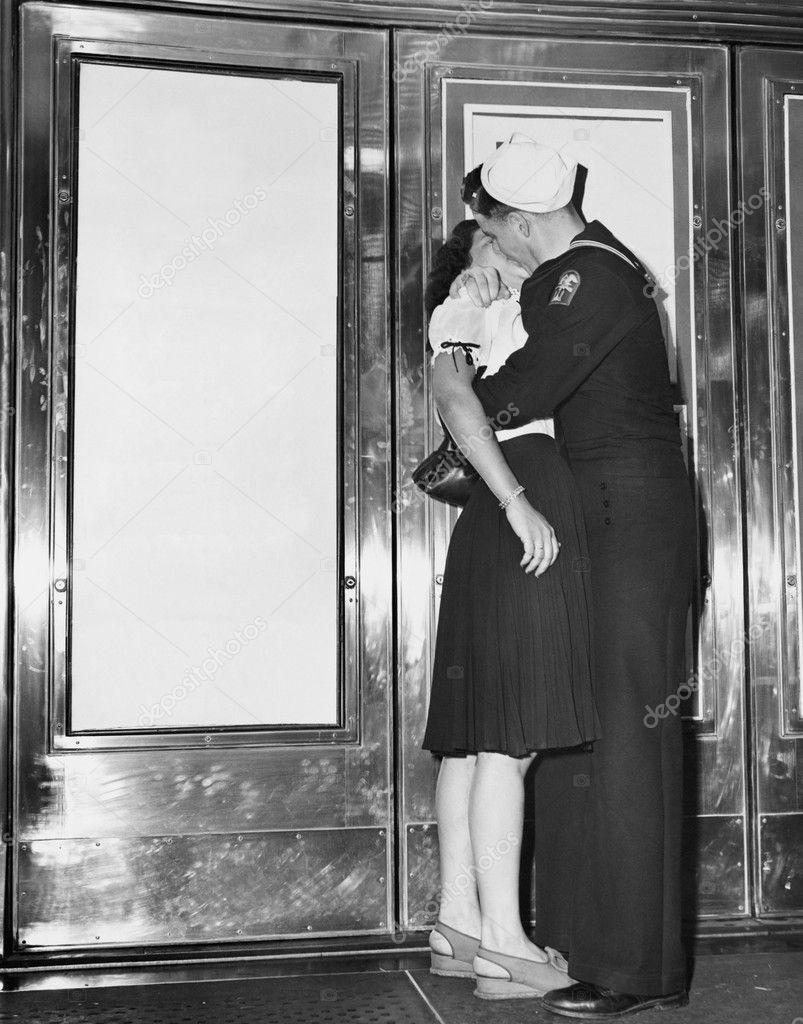 U.S. sailor and his girlfriend celebrate news of the end of war with Japan in front of the Trans-Lux Theatre in New York's Time Square, August 14, 1945