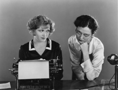 Two women with typewriter clipart