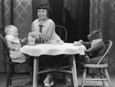 Girl having tea party with doll and bear clipart