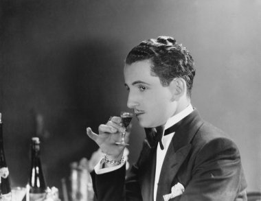 Man drinking glass of liqueur clipart