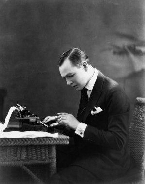 Portrait of man using typewriter clipart