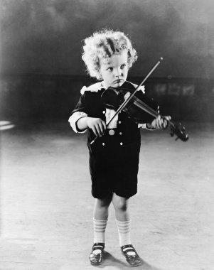 Portrait of little boy playing violin clipart