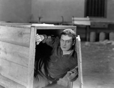 Man hiding in wooden crate clipart