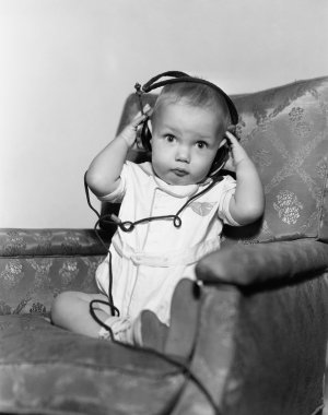 Portrait of baby wearing headphones clipart