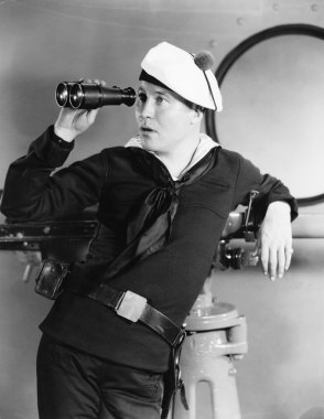 Portrait of sailor looking through binoculars clipart