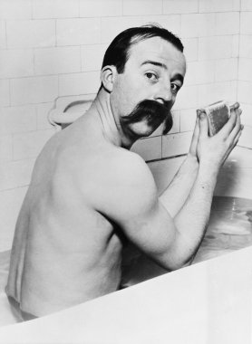 Portrait of man with huge mustache in bath clipart