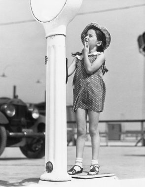 Little girl looking confused by a scale clipart