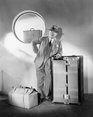 Man standing and waiting with his luggage clipart