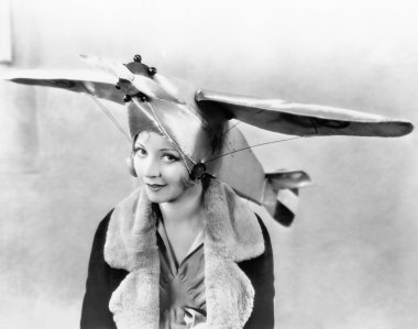 Portrait of a young woman wearing an airplane shaped cap clipart