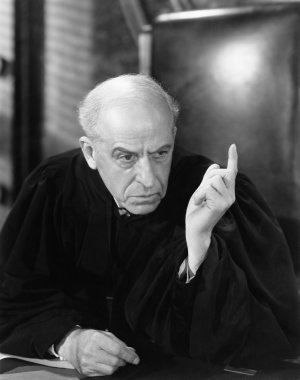 Judge in a courtroom pointing his finger up clipart