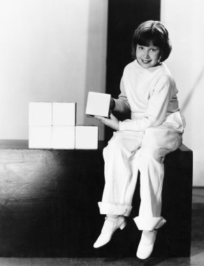 Portrait of a young girl playing with blocks clipart