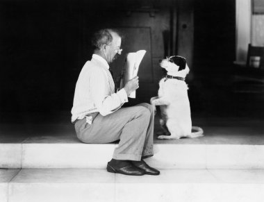 Man reading a newspaper with his dog clipart