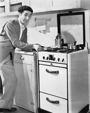 Man in a kitchen preparing food clipart