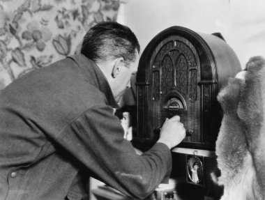 Man tuning the radio clipart