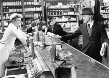 Four men at a soda fountain clipart