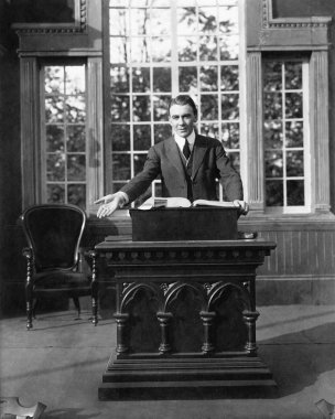Man giving a speech at a pulpit clipart