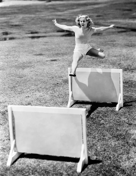Woman jumping hurdles labeled with years — Stock Photo, Image