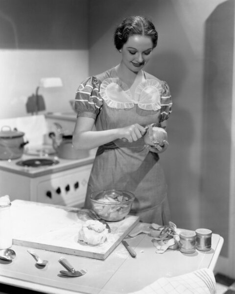 Portrait of woman cooking in kitchen