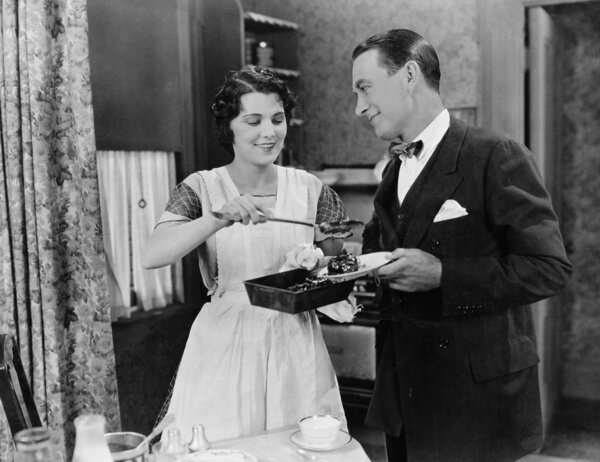 Woman serving food to man