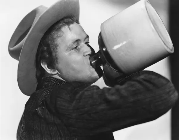 Portrait of man drinking from jug — Stock Photo, Image