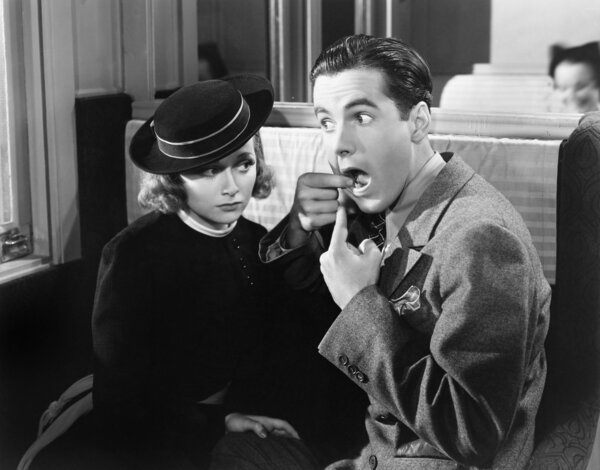 Man showing woman inside of mouth