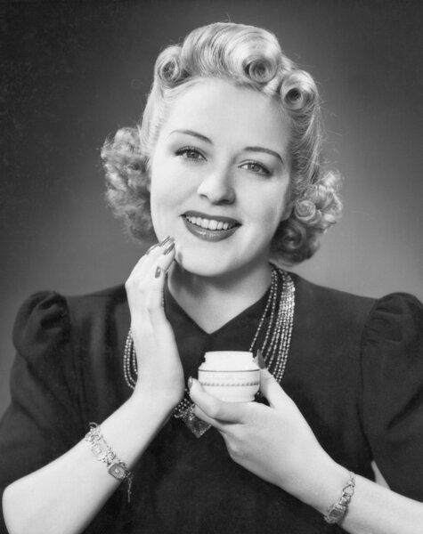 Portrait of woman applying makeup