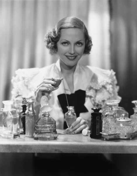 Retrato de mujer con frascos de perfume — Foto de Stock