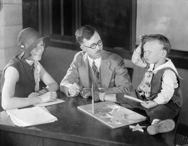 Erwachsene testen kleinen Jungen beim Puzzeln — Stockfoto