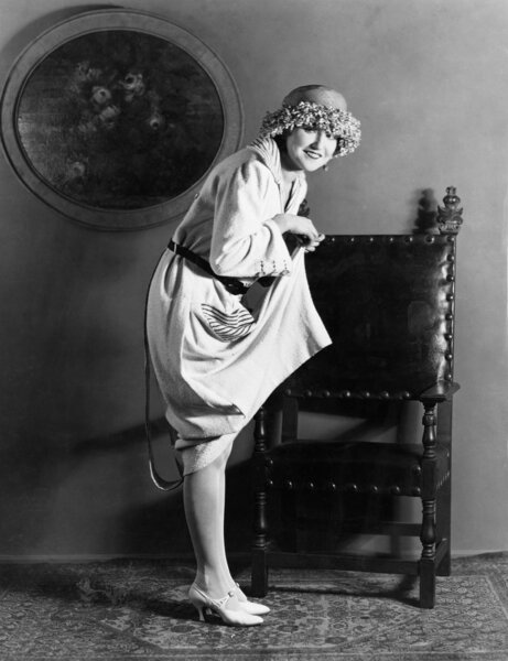 Portrait of woman lifting dress