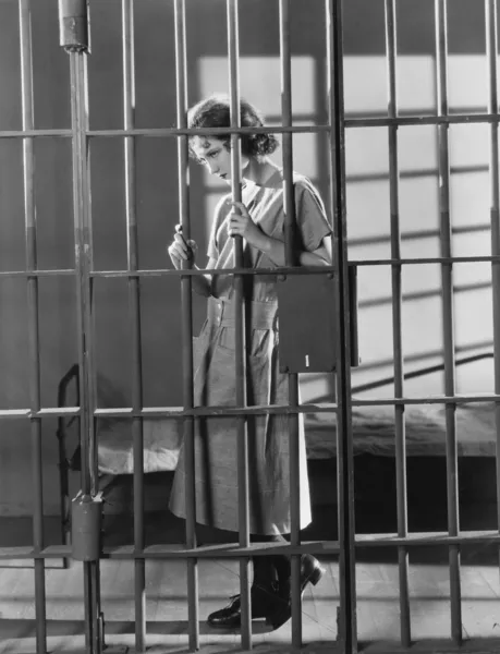 Woman in jail cell — Stock Photo, Image