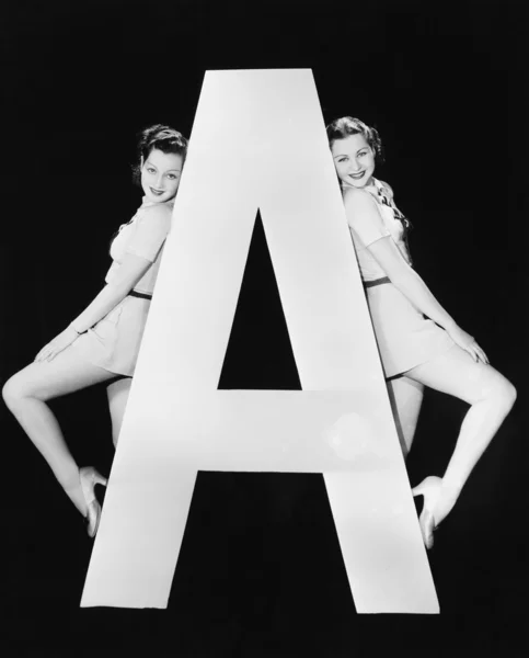 Two women with huge letter A — Stock Photo, Image