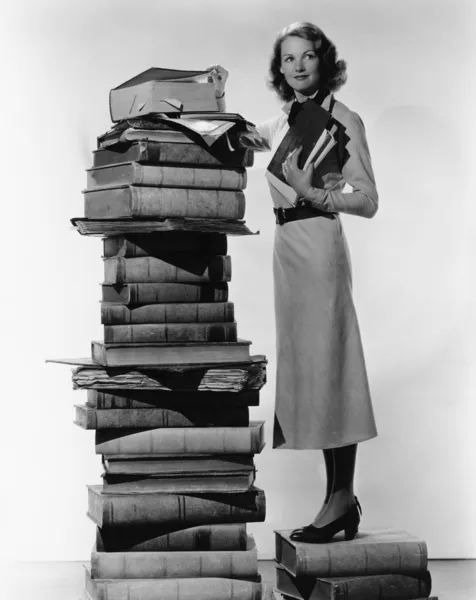 Femme avec pile de grands livres — Photo