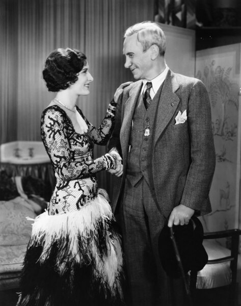 Young woman and mature man shaking hands