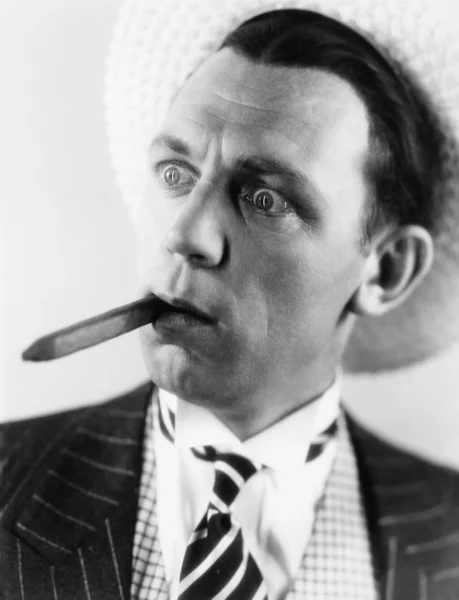 Hombre con un cigarro en la boca mirando sorprendido — Foto de Stock