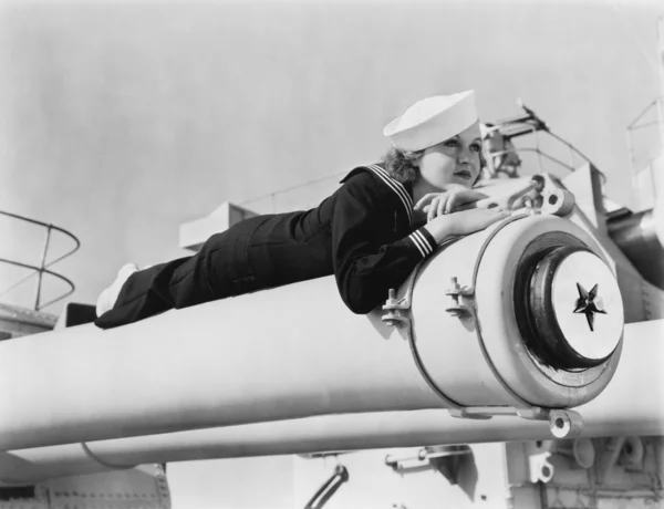 Femme en uniforme de marin allongée sur un canon — Photo