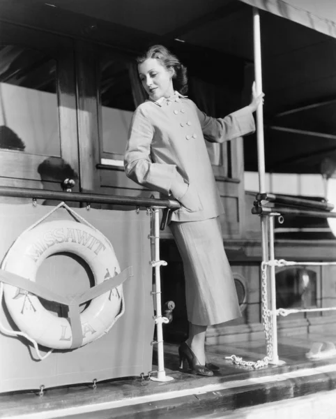 Jovem mulher de pé no corrimão de um barco — Fotografia de Stock