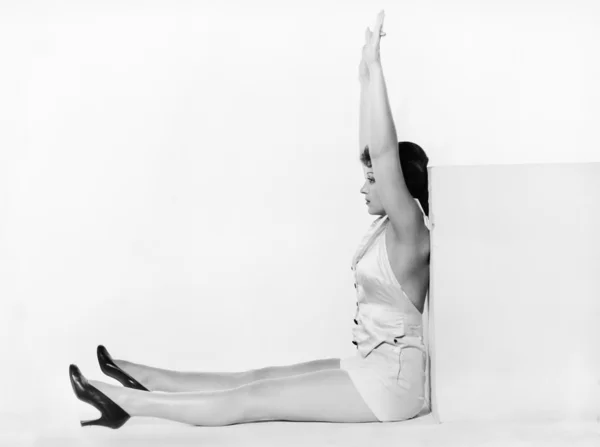 Perfil de uma jovem que se exercita contra um cubo — Fotografia de Stock