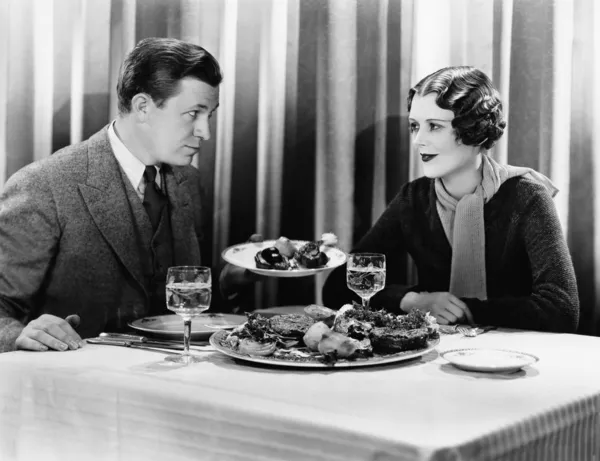 stock image Man offering food to a woman in a restaurant