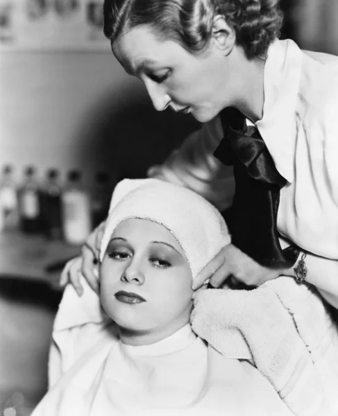 Θηλυκό κομμωτήριο στέγνωμα μαλλιών του μια νεαρή γυναίκα με μια πετσέτα σε ένα κομμωτήριο — Φωτογραφία Αρχείου