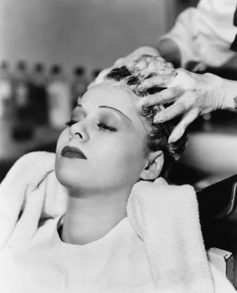 stock image Hairdresser cleaning hair of a young woman in a hair salon