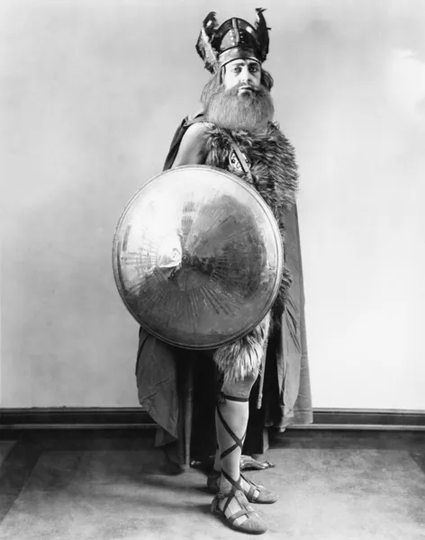 Portrait of a Viking warrior standing and holding a shield — Stock Photo, Image