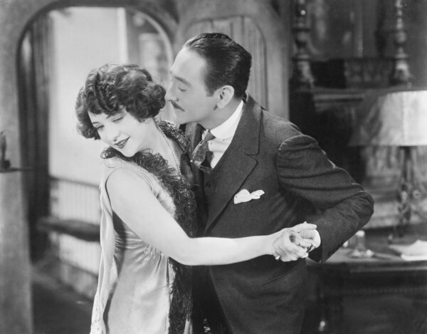 Man trying to kiss a woman who head is turned away