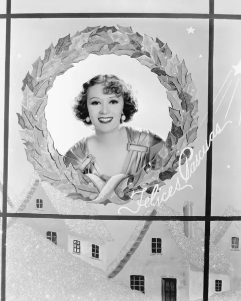 Image of a woman in a holiday wreath — Stock Photo, Image